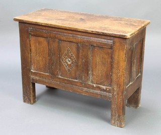 A 17th Century style oak coffer of panelled construction with hinged lid 56cm h x 74cm w x 33cm d 