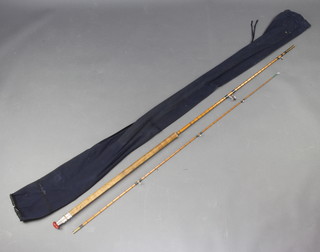An Avon style split cane fishing rod with blue cloth bag