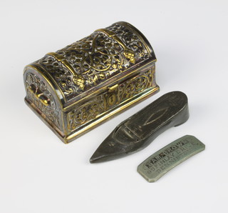 A Victorian pewter snuff box in the form of a shoe marked Constantine, a Victorian brass domed trinket box in the form of a trunk 4cm x 9cm x 6cm, an arch shaped metal label marked Sam Browne 96cm Finlay Drive Dennistoun 