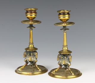 A pair of Victorian polished brass candlesticks with rams head supports 17cm x 9cm x 24cm 