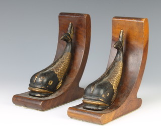 A pair of painted iron and mahogany bookends in the form of dolphins 18cm x 7cm x 13cm 