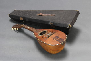 A mandolin labelled Luigi Poppi Premiata Fabbrica Di Mandolini Palermo, contained in a fibre carrying case  