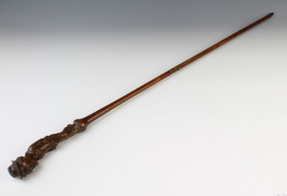 A 19th  Century Continental carved wooden walking stick the handle in the form of a behatted man with brush 