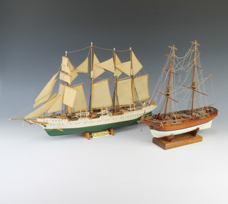 A wooden model of the Spanish ship Juan Sebastian Escano 34cm x 59cm x 6cm and a model of a 2 masted war ship 35cm x 30cm x 8cm (bow split is damaged)
