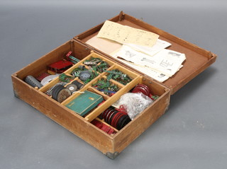 A quantity of various green and red Meccano contained in a plywood box with hinged lid together with instructions for a Meccano No.1a accessory outfit, do. No.5 outfit and various other Meccano instructions 