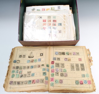 A 1930's stamp album containing various world stamps and loose leaf world stamps contained in a purple box  