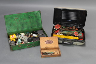 A green metal box containing various Meccano motors and a collection of green, red and yellow Meccano contained a plastic case