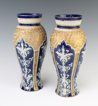 A pair of Doulton Lambeth oviform vases with stylised scrolls and flowers 27.5cm 