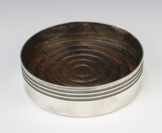 A silver coaster of plain form with wood insert 325 grams, London 1989 