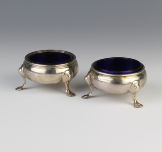 A pair of George III silver table salts on pad feet with blue glass liners, London 1764 122 grams