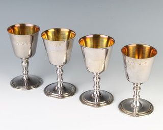 A set of 4 silver goblets of simple form with gilt interiors London 1970/73, 725 grams