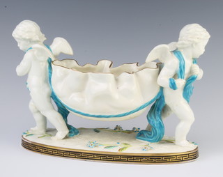 A Moore porcelain centrepiece with 2 angels carrying a leaf shaped basket 25cm 