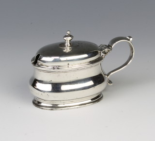 An oval silver mustard pot with blue glass liner London 1934, 85 grams 