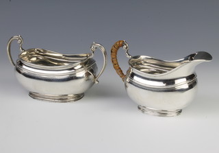 A silver cream jug and a silver 2 handled sugar bowl London 1916 and London 1913, 479 grams 