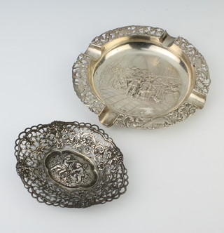 A Continental repousse silver pierced dish, decorated with cherubs, a circular do. with soldiers 180 grams 