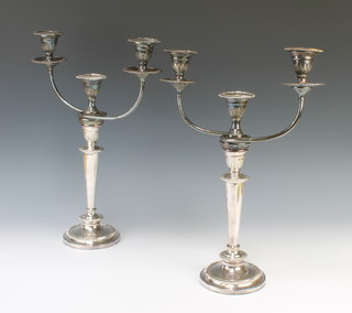 A pair of silver plated Adam style 3 light candelabra converting to single candlesticks 17cm 