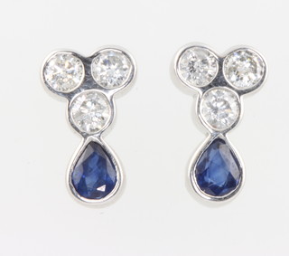 A pair of 18ct white gold sapphire and diamond ear studs, 3 brilliant cut diamonds and a pear cut emerald, the sapphires approx. 0.94ct the diamonds approx 0.82ct 13mm x 8mm  