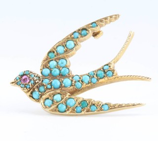 A 9ct yellow gold brooch in the form of a swallow set with turquoise beads and a ruby eye 40mm x 28mm 