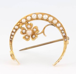 An Edwardian 15ct yellow gold crescent shaped brooch set with seed pearls 3.9 grams gross