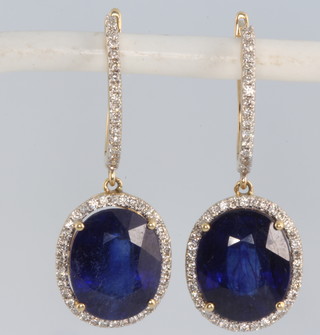 A pair of 18ct yellow gold oval sapphire and diamond earrings with treated sapphires 