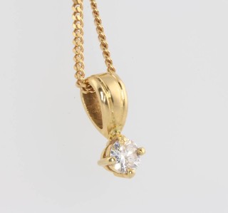 An 18ct yellow gold single stone diamond pendant on a 9ct gold chain, approx. 0.3ct