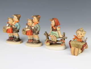 Four Hummel figures - Surprise 10cm, a boy with concertina 6cm, a girl on a fence 10cm and a boy and girl 10cm 