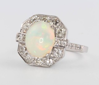 An 18ct white gold cabochon cut oval opal and diamond dress ring size P 