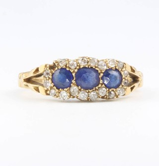 An 18ct yellow gold sapphire and diamond triple cluster ring size N 