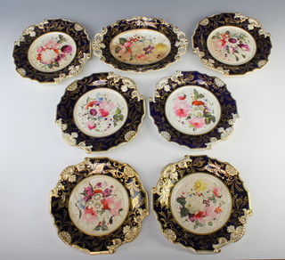 An English 19th Century porcelain dessert service with blue and gilt borders enclosing spring flowers comprising 6 plates and 1 dish 