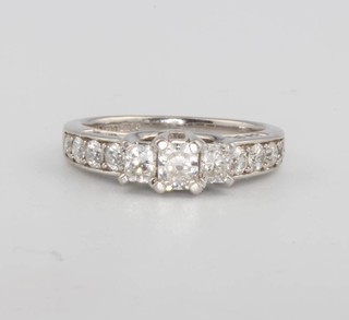 A 14ct white gold 3 stone diamond ring with diamond set shoulders and sides approx. 1.25ct size J 
