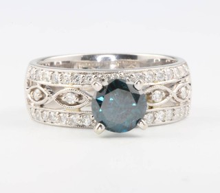 An 18ct white gold fancy blue diamond ring with diamond shoulders, the 1ct centre stone enhanced size N 1/2