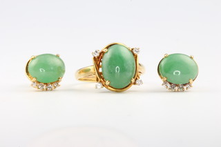An 18ct yellow gold cabochon cut jade and diamond ring size L 1/2, a pair of do. ear studs, makers mark AG 