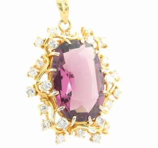 A yellow gold amethyst and diamond pendant the oval cut centre stone surrounded by brilliant cut diamonds 40mm x 27mm 