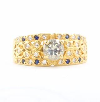 A yellow gold diamond ring with a centre brilliant cut stone the shank with paste stones size M 
