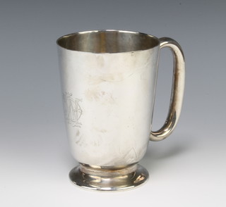 A silver mug of plain form with chased armorial Birmingham 1933, 13cm, 328 grams