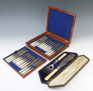 A set of 12 Victorian silver and mother of pearl dessert eaters in a mahogany canteen, Sheffield 1838 together with a pair of cased plated fish servers 
