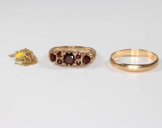 A 9ct yellow gold wedding band size Q 1/2, a garnet set 9ct ring and a chain, gross 4.5 grams