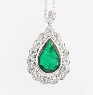 An 18ct white gold pear cut emerald and diamond pendant, the centre stone approx. 2.5ct surrounded by brilliant cut diamonds approx. 1.5ct on an 18ct white gold chain 