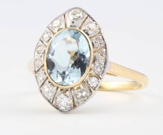 An oval aquamarine and diamond cluster ring, the centre stone approx. 1.6ct surrounded by brilliant cut diamonds approx. 0.4ct size N 1/2