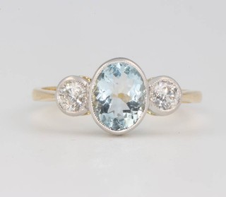 An 18ct yellow gold aquamarine and diamond ring size P 1/2