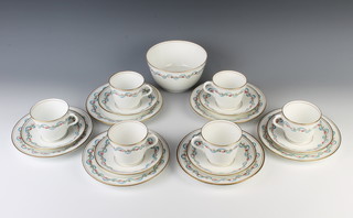 An Edwardian part tea set decorated with flowers and swags comprising 6 tea cups, 6 saucers, 6 side plates and a sugar bowl 