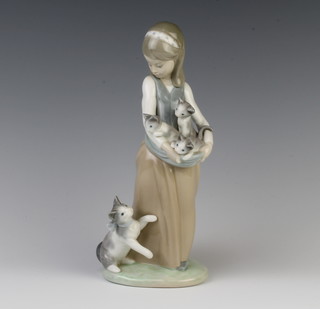 A Lladro figure of a girl holding kittens with a cat at her feet 25cm 