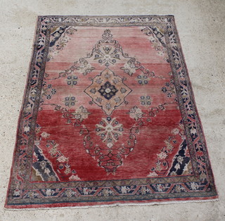 A red ground Persian rug with central medallion 192cm x 139cm 