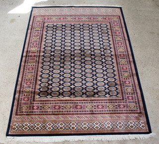 A Belgian cotton blue and white ground Bokhara style carpet with numerous octagons to the centre 280cm x 200cm 
 