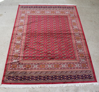A red and white ground Bokhara style Belgian cotton carpet with numerous octagons to the centre 280cm x 200cm 