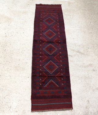 A red and blue ground Meshwani runner with 4 diamonds to the centre within a multi-row border  253cm x 63cm 