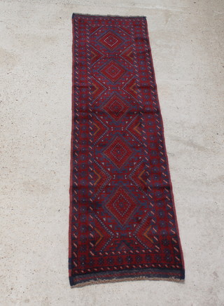 A red and blue ground Meshwani runner with 5 diamonds to the centre within multi row borders 247cm x 67cm 
