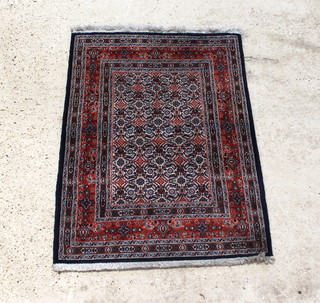 A Persian blue and tan ground Khorassan rug 113 x 81cm 