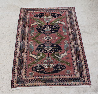 A pink ground Caucasian rug, signed 185 x 127cm 