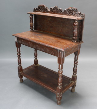 A Victorian carved oak hall table, the raised back fitted a shelf with carved apron and undertier, raised on turned and block supports 112cm h x 85cm w x 40cm d 